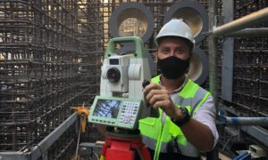 Professional land surveyor using a total station on a commercial construction site in Lake Havasu while conducting an ALTA survey
