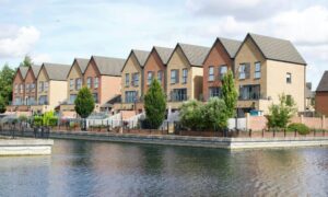Modern riverfront homes showing why homeowners may need to update their elevation certificate after flooding