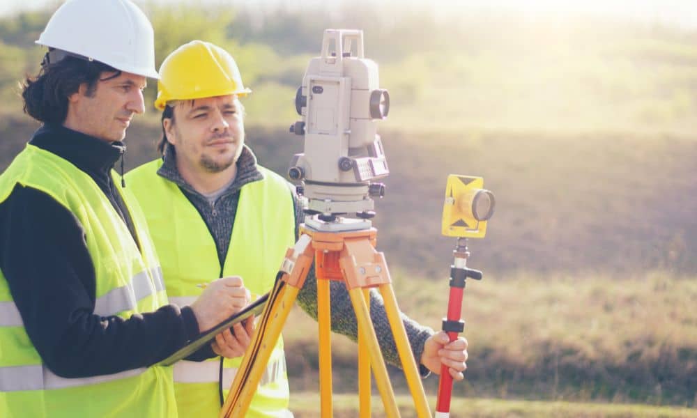 surveyors conducting ALTA survey preparation - ALTA SURVEY Arizona Two land surveyors using equipment to prepare for an ALTA survey, emphasizing the importance of accurate documentation