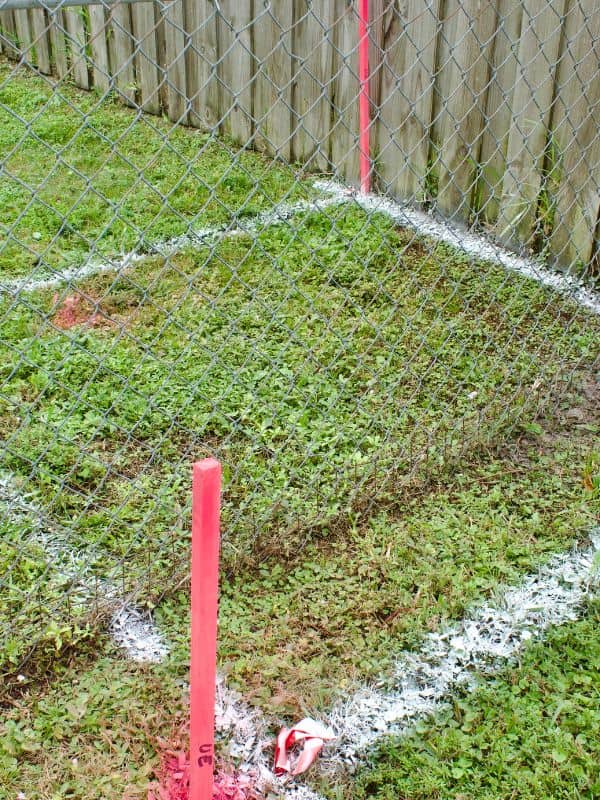 Boundary survey markers showing property lines near a fence in Bullhead City
