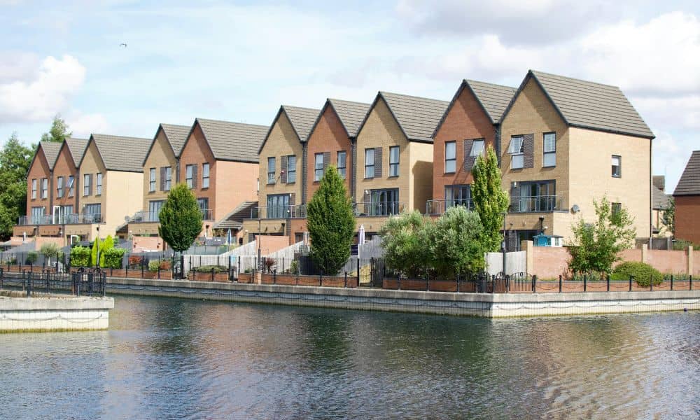 Modern riverfront homes showing why homeowners may need to update their elevation certificate after flooding
