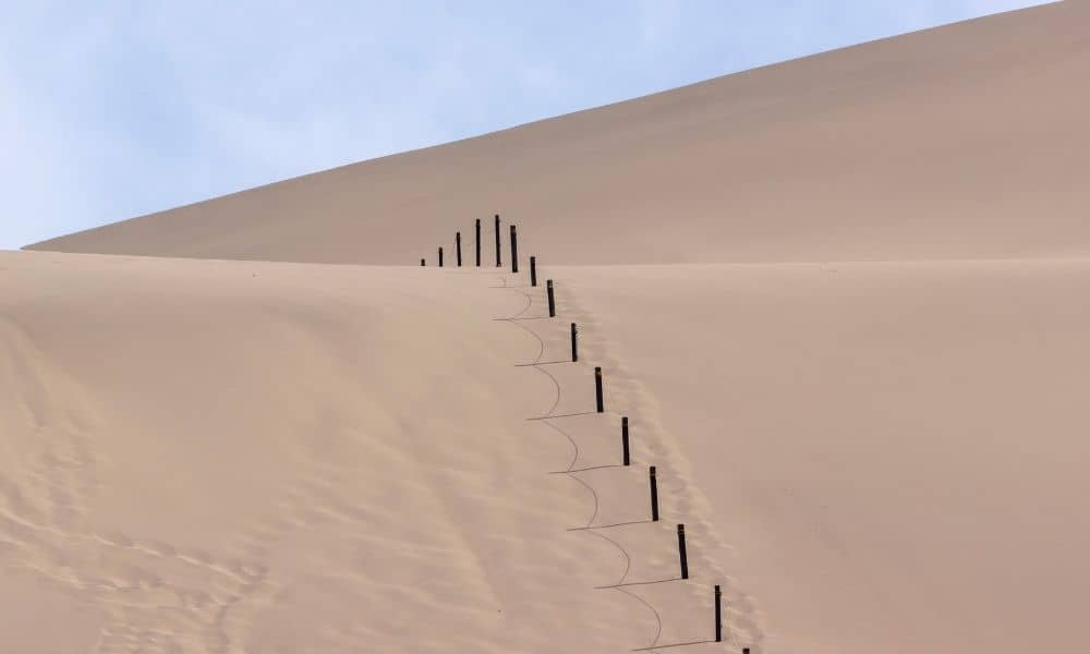 Desert land boundary markers fence planning - ALTA SURVEY Arizona Survey stakes marking a boundary on desert land where a property line survey helps confirm accurate placement before building a fence or driveway