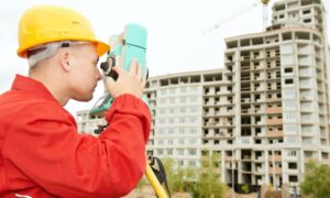 Commercial surveyor construction site - ALTA SURVEY Arizona Surveyor performing a commercial land survey at a multi-story construction site