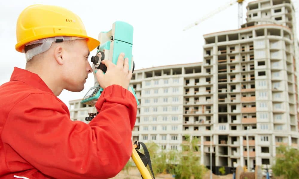 Commercial surveyor construction site - ALTA SURVEY Arizona Surveyor performing a commercial land survey at a multi-story construction site