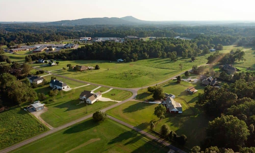 Aerial view of residential land with large open parcels and roads before land is divided