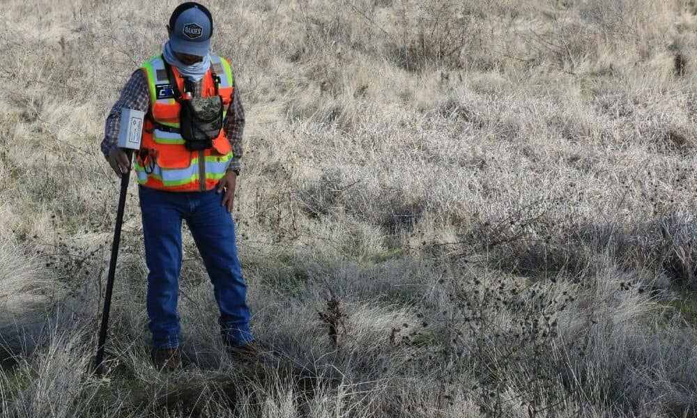 Surveyor checking site layout with GPS equipment before construction begins