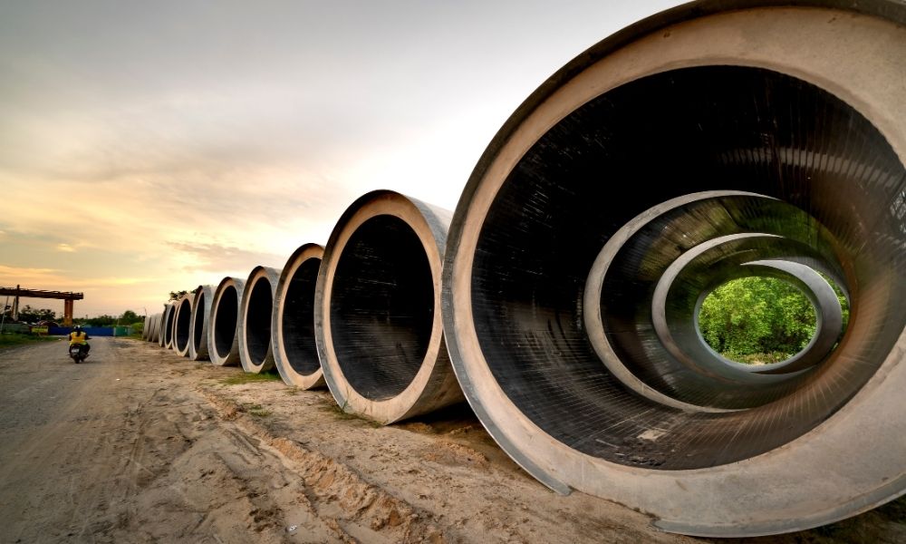 Construction survey semiconductor utility yard pipes - ALTA SURVEY Arizona Large concrete pipes at an active construction site, relevant to construction survey work