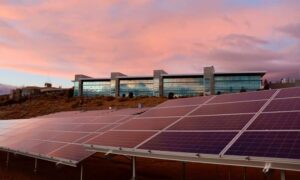 Alta survey solar easements - ALTA SURVEY Arizona Commercial building with a large solar panel installation covering part of the surrounding property under a clear evening sky
